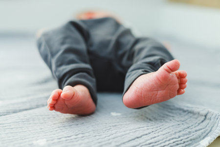 Tiny baby feet on a soft blanket embody childhood joy, perfect for heartwarming family gatherings that celebrate the cherished innocence and love among our loved onesの写真素材