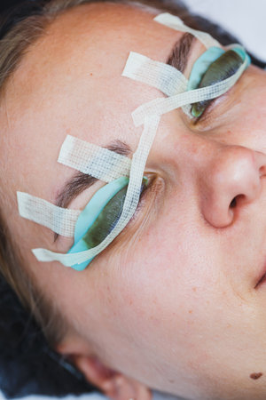 A woman enjoys a luxurious beauty treatment experience, donning eye pads for added safety and utmost comfort as she fully immerses herself in pure relaxation and tranquilityの写真素材
