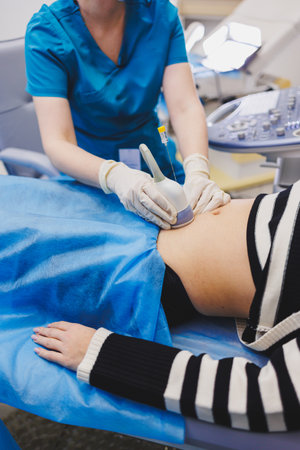 Shot of a pregnant woman during an ultrasound scan in a fertility clinic. Examination healthcare pregnancy gynecology people professionalism trustの写真素材