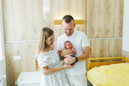 In a peaceful hospital setting, a loving couple cherishes their newborn, highlighting the joy and bond of new parenthood, filled with love and hope for the futureの写真素材