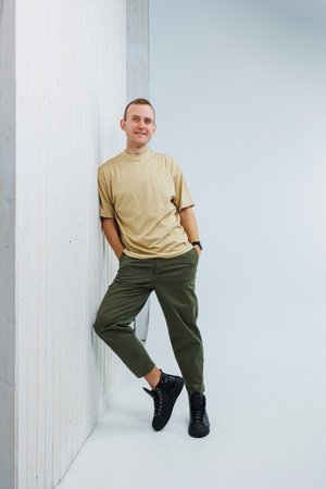 A young handsome man in casual clothes poses on a white background in the studioの写真素材