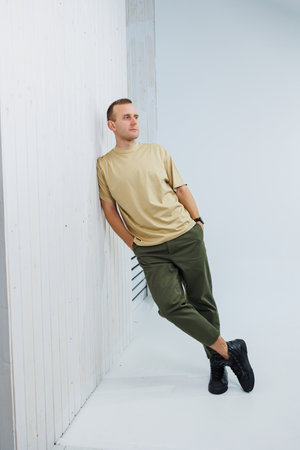 A young handsome man in casual clothes poses on a white background in the studioの写真素材