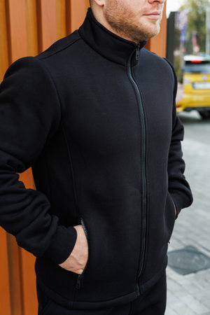 A contemporary black jacket showcases a sleek and stylish design, making it perfect for urban casual environments and ideal for easy layering during cool weather conditionsの写真素材
