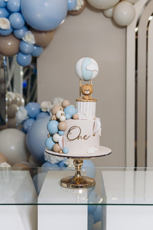 Sweet cake for a child's birthday decorated with a teddy bear. Two-story cake for a child. 1st birthday party for a child.の写真素材