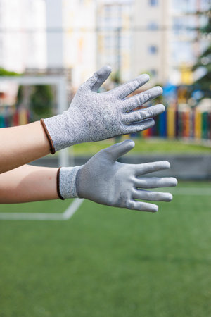 Gloves on hands for a construction worker. Durable gloves for dirty work.
