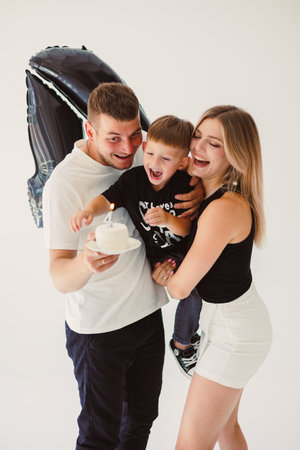 Happy family with little son on white background. 4 year old boy with mom and dad on white background. Funny photo of family couple with son.の写真素材