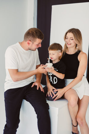 In a beautifully designed studio, parents share a heartwarming bond with their young son, capturing the deep affection, joy, and beautiful moments that define family lifeの写真素材