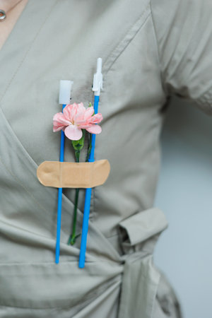 This whimsical portrayal of healthcare features vibrant pink flowers with medical tools, showcasing...