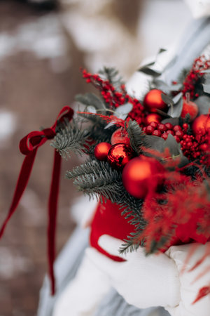 This is a stunning and beautiful arrangement of bright red ornaments, fresh berries, and lush greenery, ideal for enhancing your Christmas decor and spreading holiday joy to allの写真素材