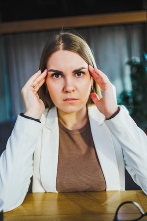 A dedicated young professional is stressed from their demanding job, underscoring the urgent need to prioritize mental health in todays highpressure business environmentの写真素材