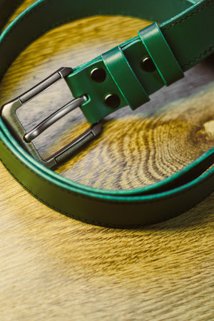 This stylish green leather belt showcases a sleek metal buckle design, making it perfect for both casual and formal outfitsa true musthave accessory for any wardrobeの写真素材
