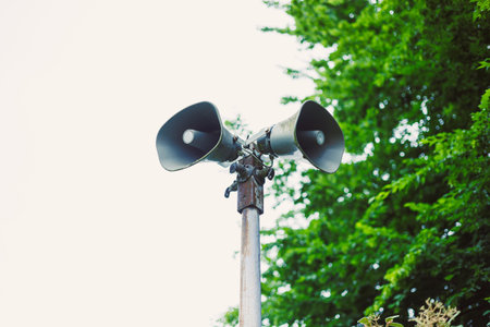 These outdoor megaphone speakers are securely mounted on a pole, ideal for announcements in parks,...