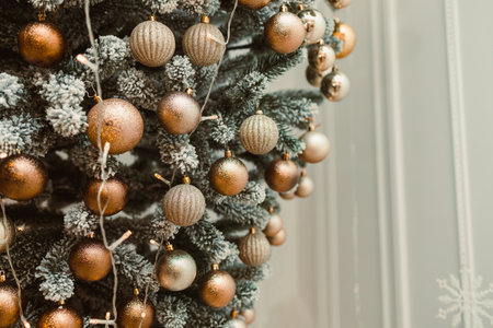 A beautifully adorned Christmas tree, showcasing shimmering gold and silver ornaments, creates an enchanting festive atmosphere that is perfect for cozy holiday celebrationsの写真素材
