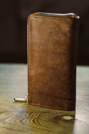 Discover this elegant brown leather wallet, perfect for organizing cash and cards. A timeless...