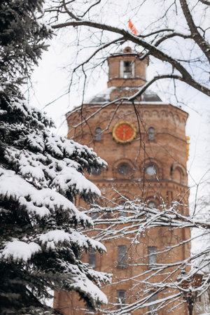 This winter scene showcases a historic tower blanketed in white snow among frosted trees, perfect for photography lovers who appreciate seasonal beauty and architectureの写真素材