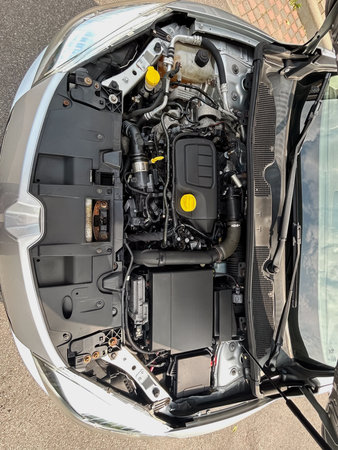 Examine the intricate design of this cars engine bay, showcasing advanced technology and components...