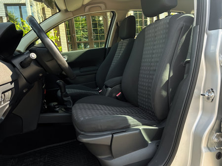 Explore the stylish interior of this modern car with comfortable seats and an elegant dashboard, perfect for daily commutes and enjoyable road trips with family or friendsの写真素材