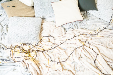 Imagine a cozy bedroom with soft cushions, warm textiles, and twinkling lights, creating a relaxing atmosphere ideal for unwinding and enjoying peaceful nightsの写真素材