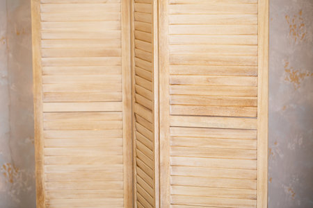 This beautifully crafted wooden divider features a stylish slatted design that not only enhances privacy but also adds a charming rustic touch to homes, offices, or special eventsの写真素材