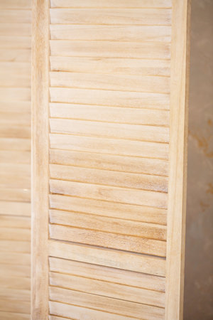 A closeup of a stylish wooden shutter showcases its natural texture, perfect for interior design, home decor, and artistic backgroundsの写真素材