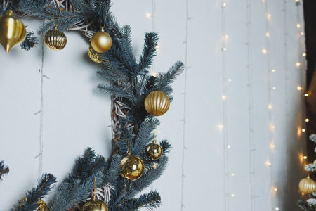 This beautifully crafted Christmas wreath features stunning golden ornaments and twinkling lights, perfect for enhancing your holiday decorations and celebrationsの写真素材