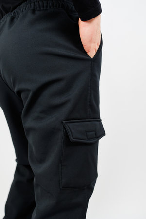 Discover stylish and trendy black cargo pants that feature spacious pockets and a comfortable elastic waistband, making them ideal for casual outings or various outdoor activitiesの写真素材