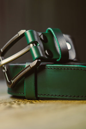 This stylish green leather belt showcases a robust metal buckle, making it an ideal accessory for enhancing your wardrobe and infusing sophistication into any outfit you chooseの写真素材