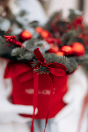 This is a truly stunning festive arrangement that showcases vibrant ornaments and rich, lush greenery, making it perfect for all your holiday decorations or thoughtful gift givingの写真素材