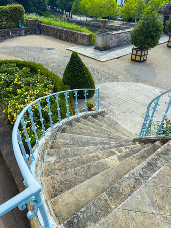 This picturesque view features a graceful stone staircase leading down, surrounded by manicured gardens and vibrant foliage, perfect for serene outdoor experiencesの写真素材