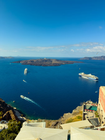 ships Cruise navigate the tranquil waters of Santorini, showcasing the beauty of volcanic islands while the sun shines brightly overhead. The scene radiates calm and adventure.の写真素材