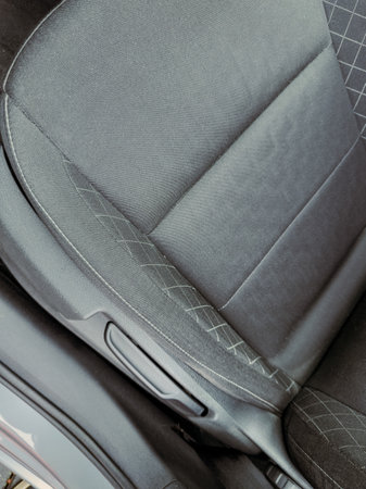 This close-up view highlights the smooth texture and contemporary pattern of a car seat, emphasizing...