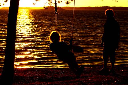 adult family couple have fun at the beach at sunset time