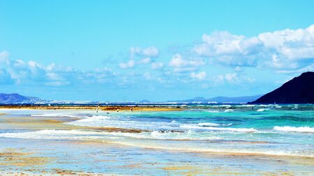 beautiful tropical sand beach, perfect water surface of the ocean and blue skyの写真素材