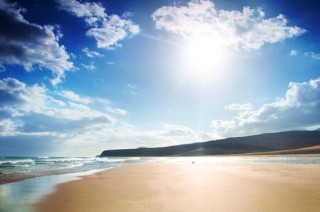 beautiful tropical sand beach, perfect water surface of the ocean and blue skyの写真素材