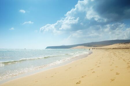 beautiful tropical sand beach, perfect water surface of the ocean and blue skyの写真素材