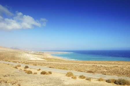 beautiful tropical sand beach, perfect water surface of the ocean and blue skyの写真素材