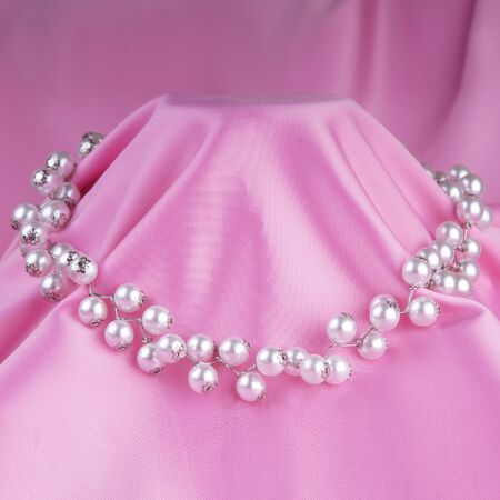 fashion necklace on pinke silk backgroundの写真素材