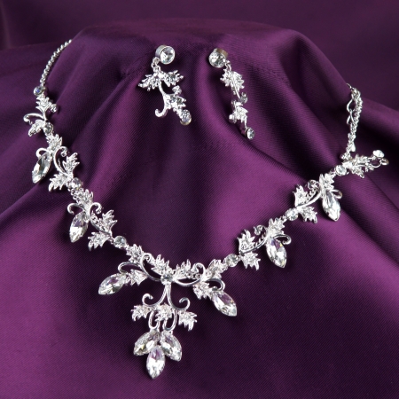 fashion necklace and earrings on purple silk backgroundの写真素材