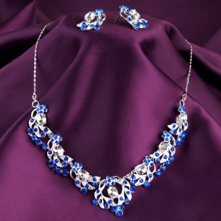 fashion necklace and earrings on purple silk backgroundの写真素材