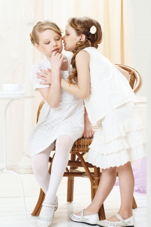 portrait of two gossiping girlsの写真素材