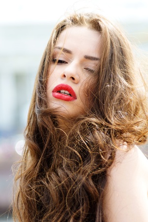 outdoor fashion portrait of young beautiful woman with long dair hair の写真素材