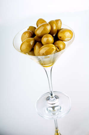 green olives in martini glassの写真素材