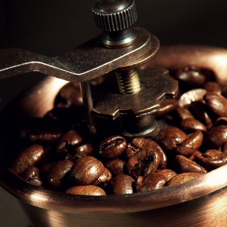 coffee mill. close up of coffee grinder with beansの写真素材