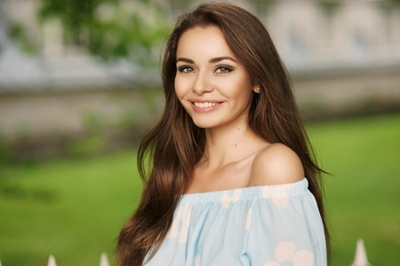 Young beautiful woman with long brunette hair and perfect smile.の写真素材