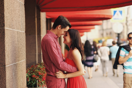 Romantic couple hugging at city street. Happy couple laughing together.の写真素材