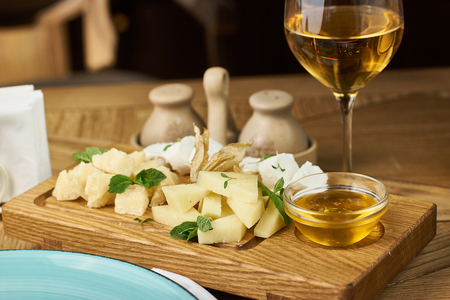 Cheese plate with honey and wineの写真素材