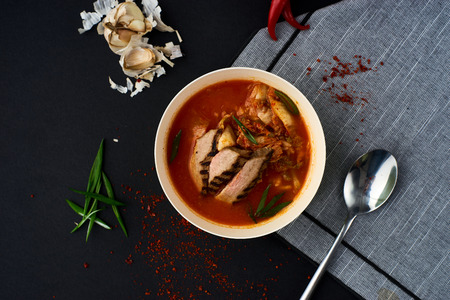 Korean cuisine. Kimchi soup on black background.の写真素材