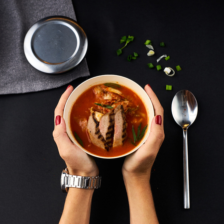 Korean cuisine. Kimchi soup on black background.の写真素材