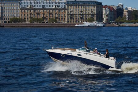 SAINT-PETERSBURG, RUSSIA - MAY 7, 2018: Friends having fun at motor boat on water on MAY 7, 2018 in Saint-Petersburg, Russia.のeditorial素材