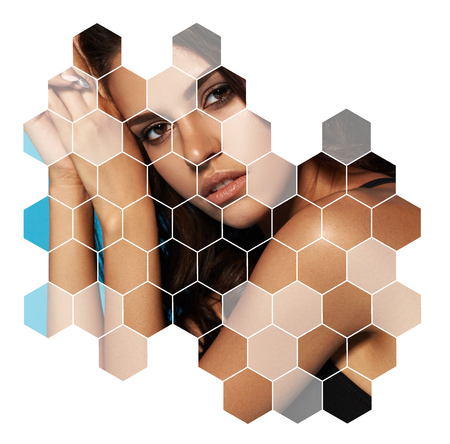 Young sexy slim tanned woman in black swimsuit posingon blue background. Fashion portrait of beautiful girl with long wavy brunette hair. Swimwear or bikini model. Closeup portraitの写真素材